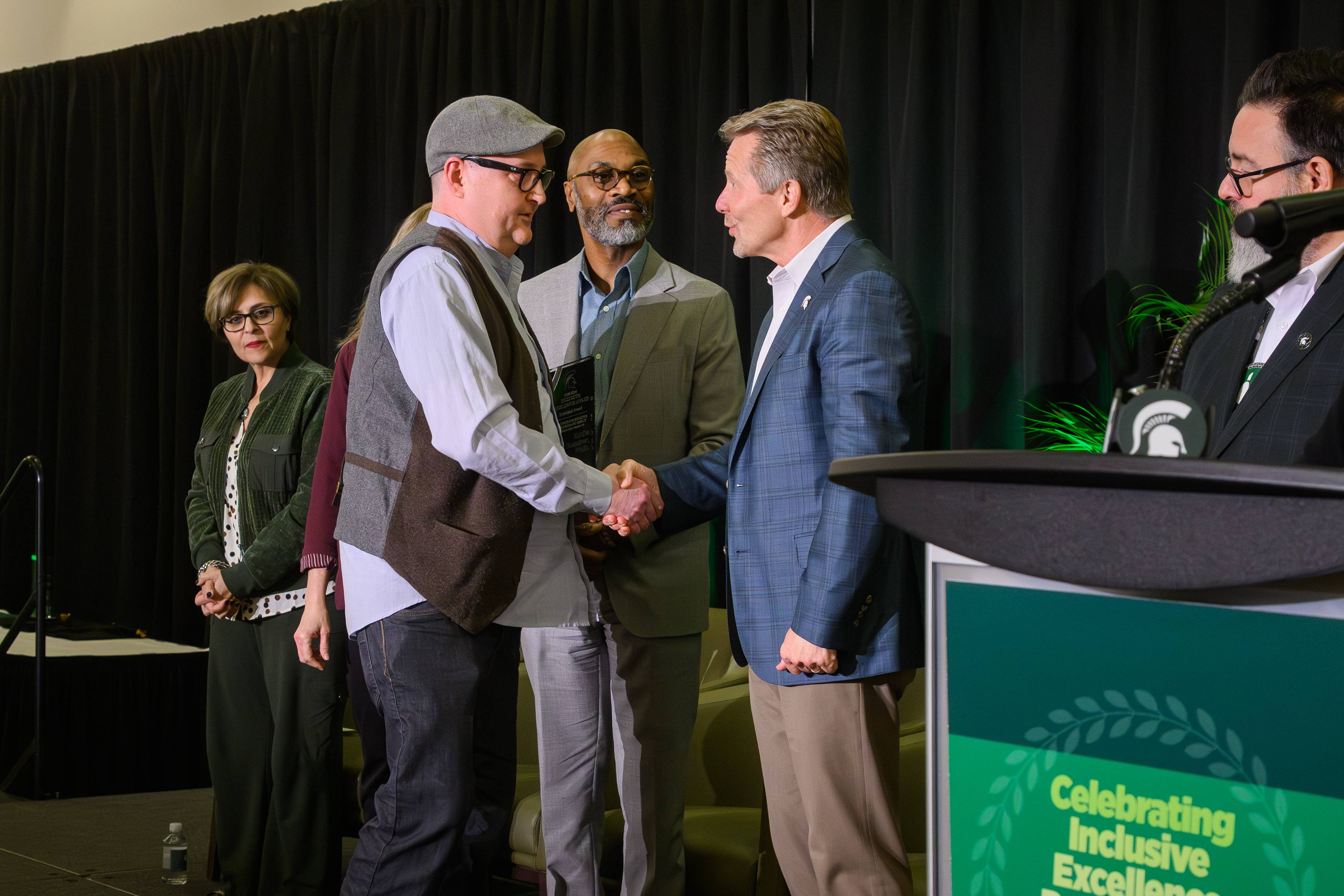 Eddie Boucher, shaking hands with MSU President Kevin Guskiewicz during the Inclusive Excellence Awards Ceremony.