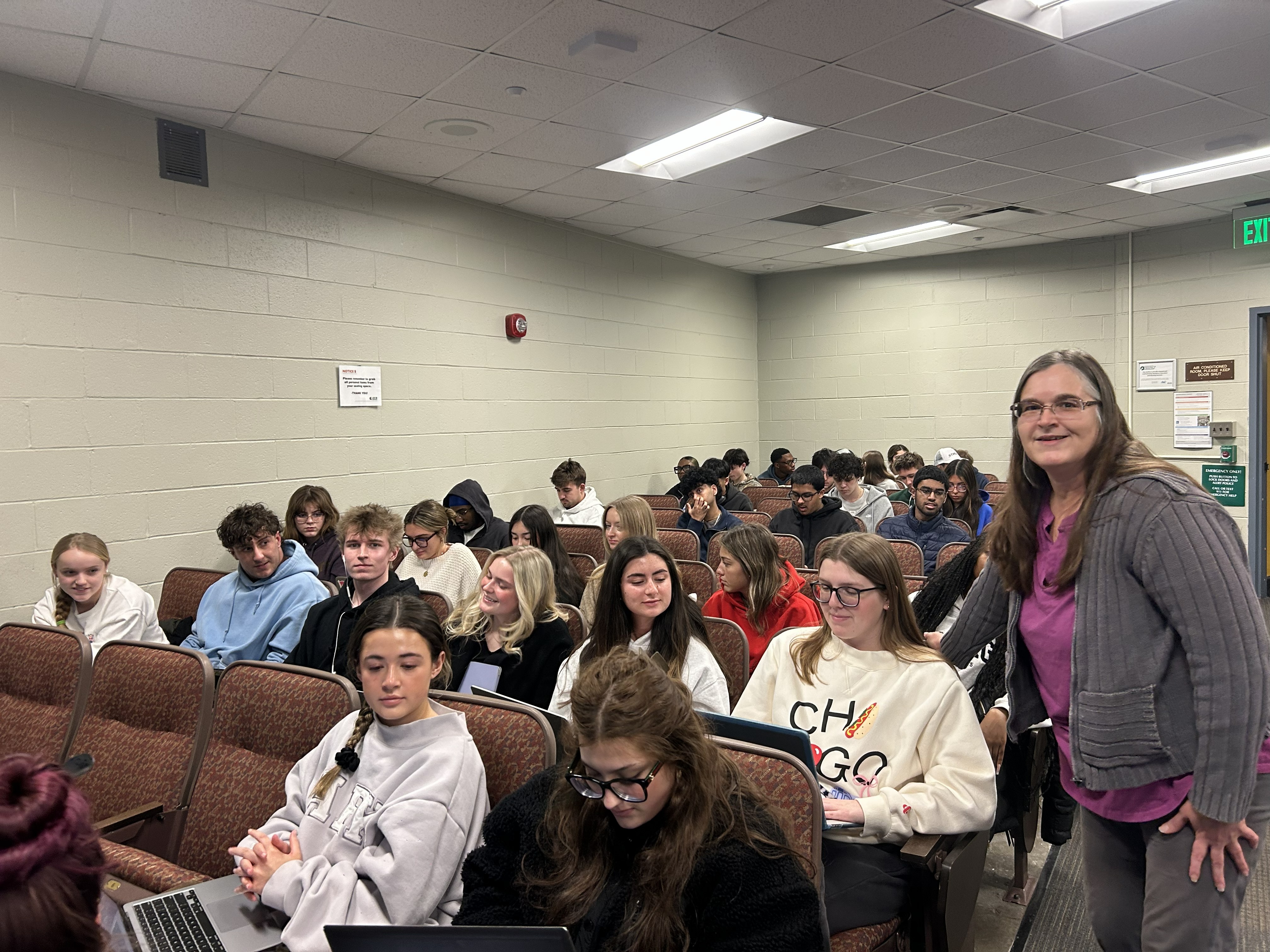 Professor Marcie Cowley standing in the classroom with her students seated. 