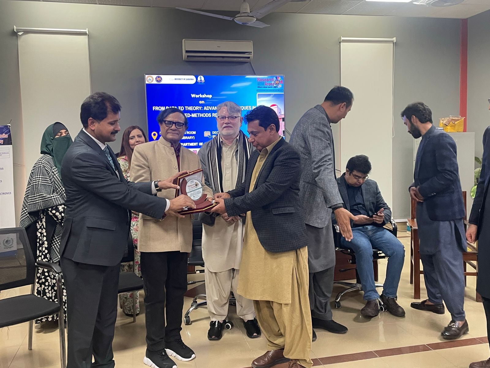 Dr. Hussain with other presenters in Pakistan.