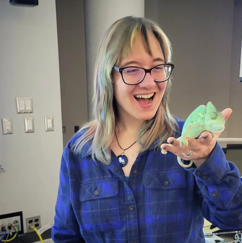 Professor Seven Mattes holding an iguana. 