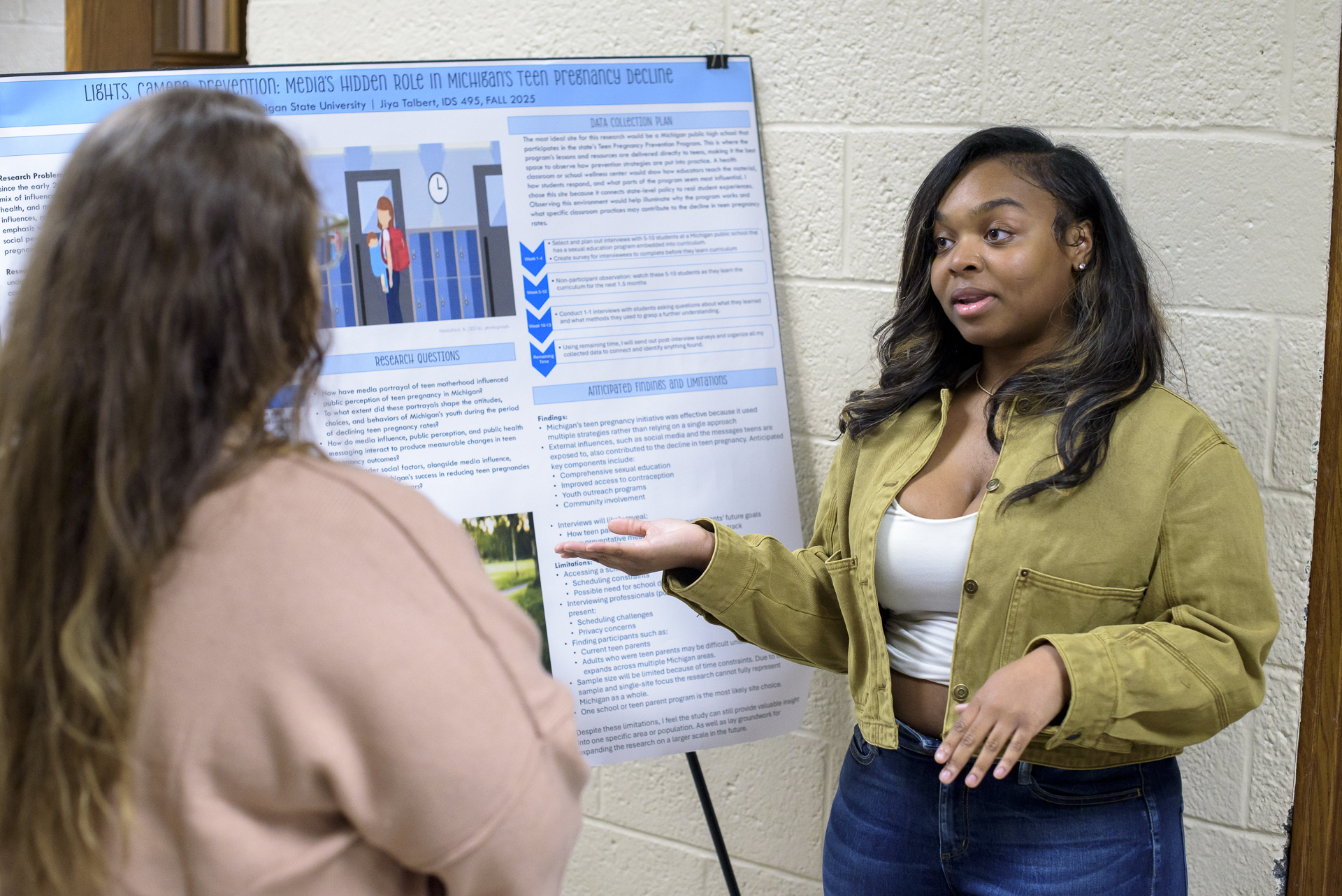Photo of an MSU student presenting her research poster