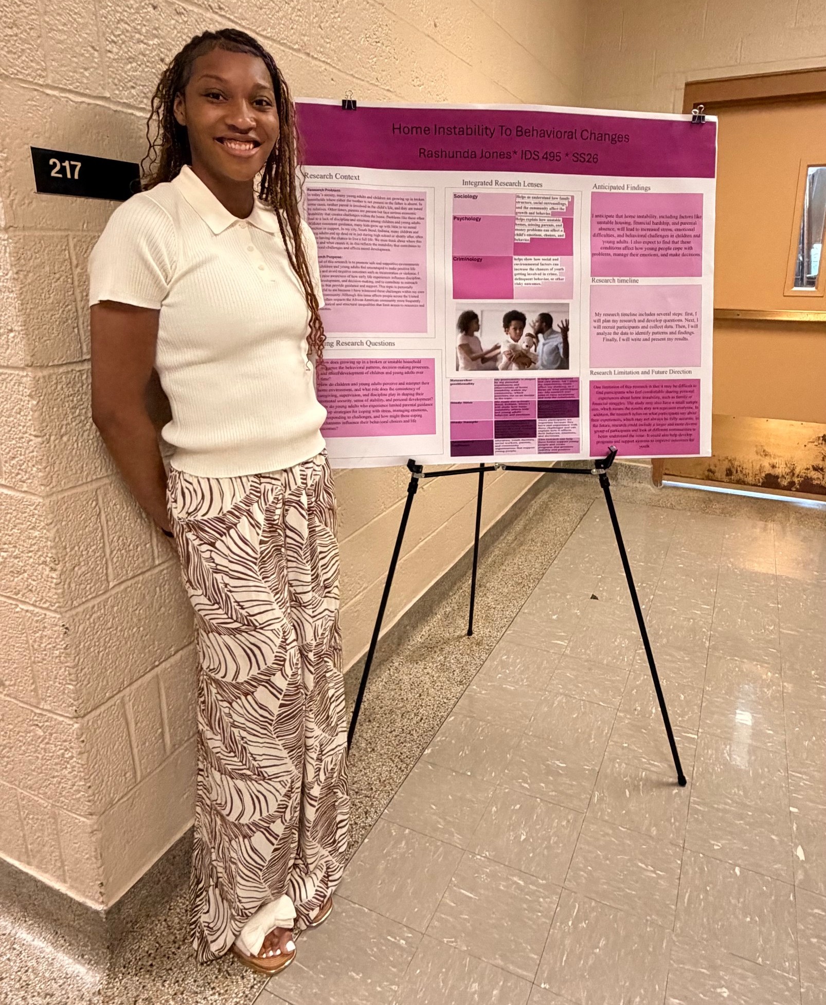 MSU student standing next to her research poster.